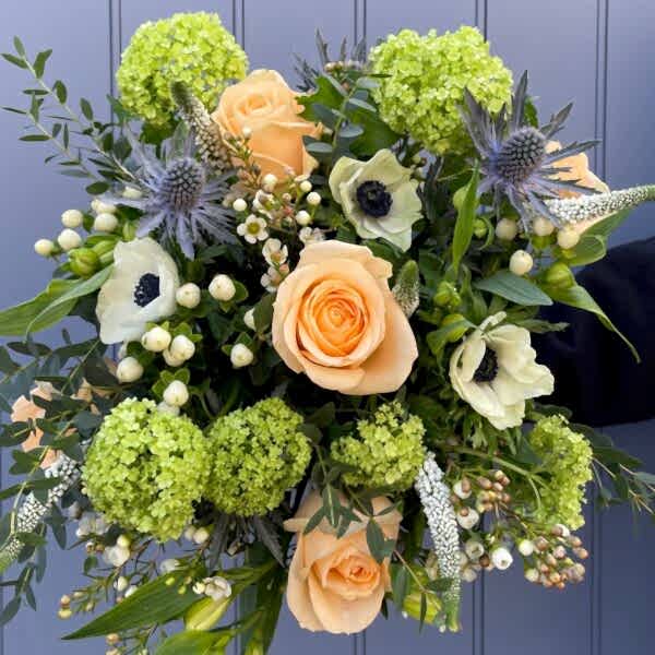 Peach roses, blue and white flower bouquet