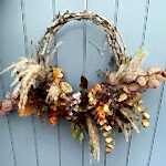 Vine wreath with autumn colours and flowers on