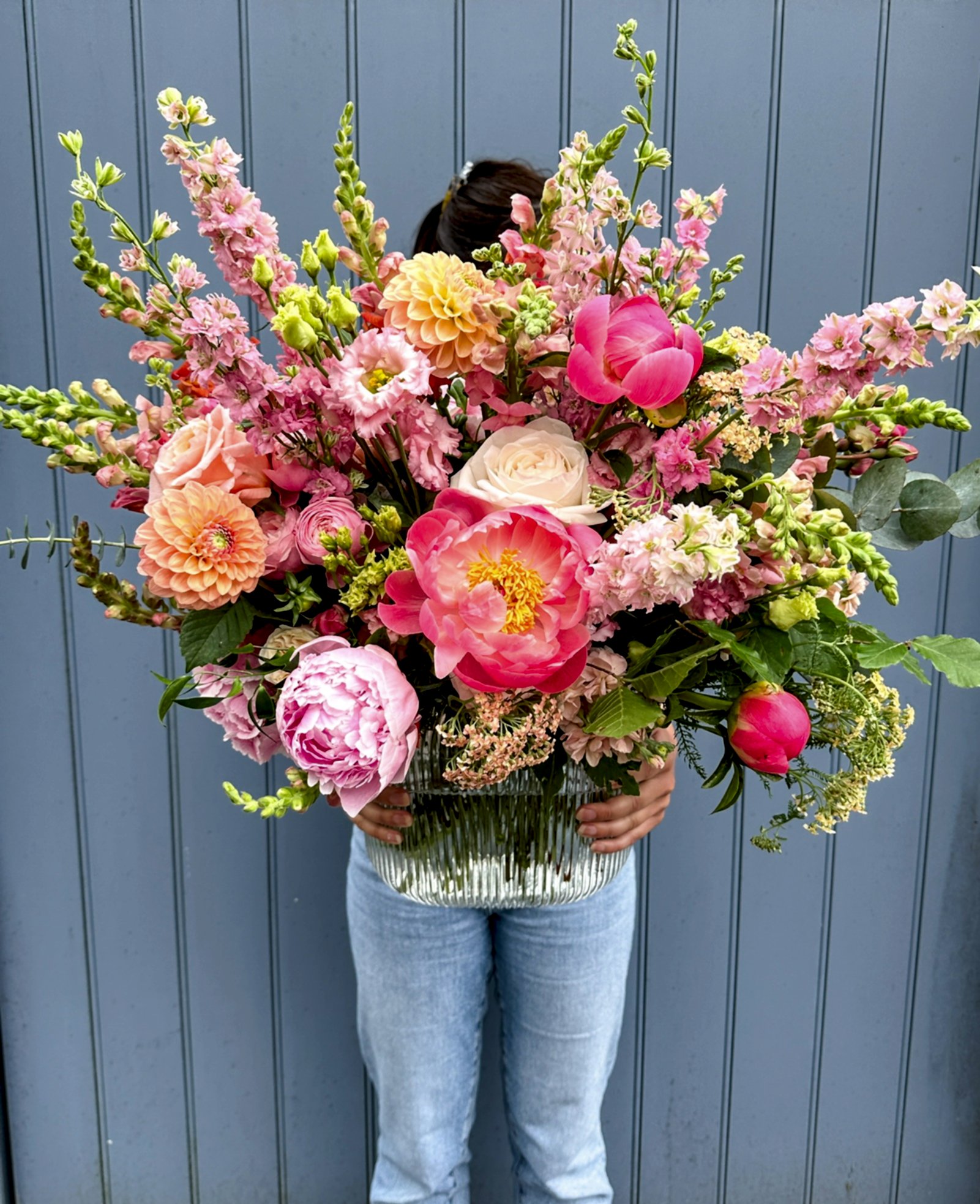 Peach, pink and coral vase display filled with seasonal blooms